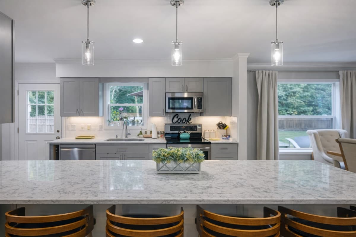 Fully equipped kitchen with stainless appliances, Keurig and drip coffee makers, and basic spices