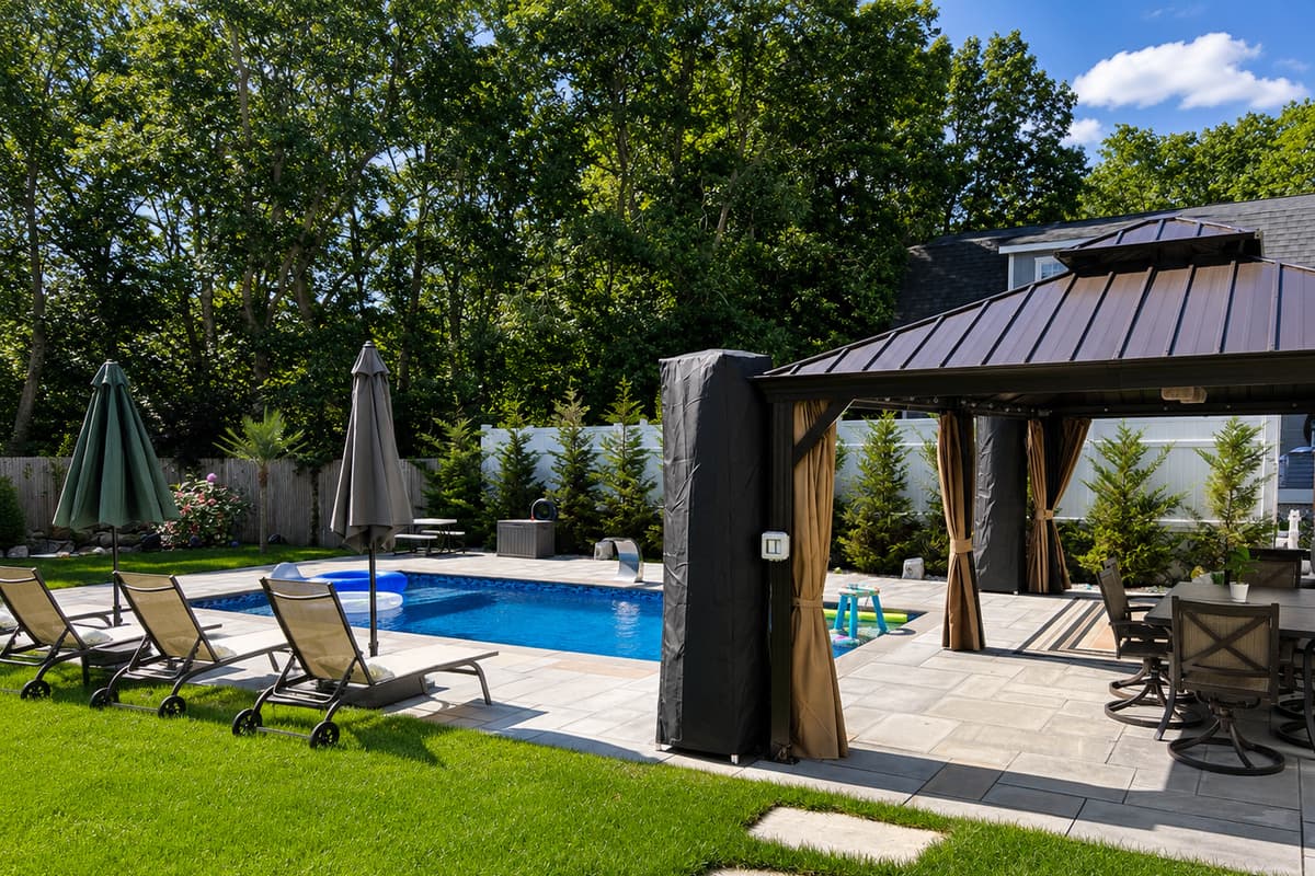 Sun-drenched pool patio with loungers and umbrellas