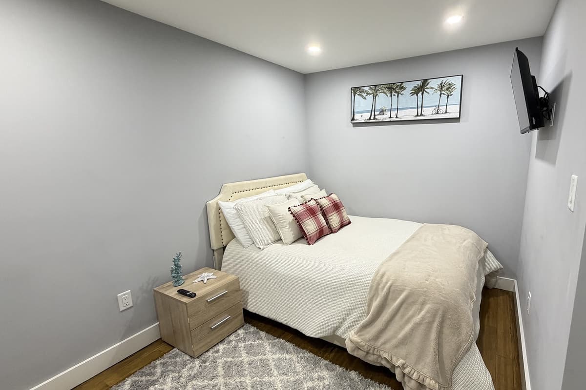 Bedroom 5 (basement) with queen bed and smart TV