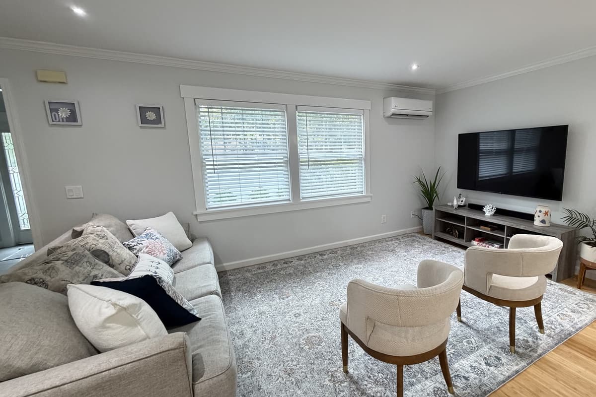 Bright sitting room with smart TV and cozy seating